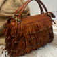 Borsa in pelle con frangine borchiate