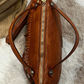 Borsa in pelle con frangine borchiate